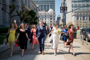 wedding party walking in front of San Francisco city hall