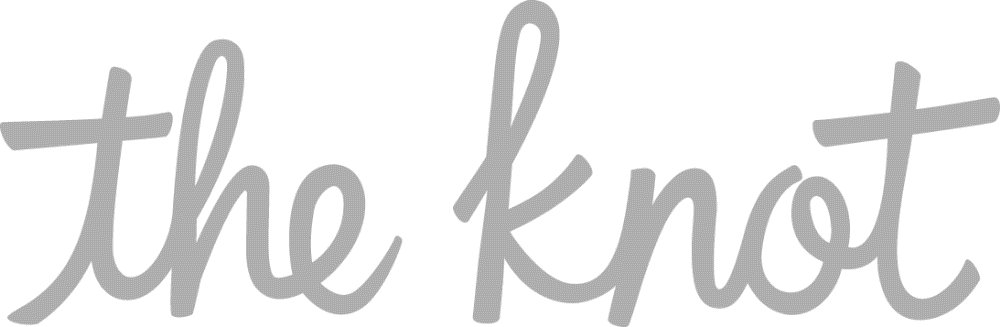 Gray cursive text that reads “the knot” on a light background.